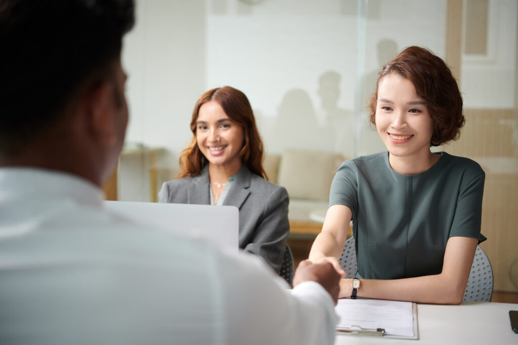 A job applicant shaking hands with an HR manager in a job interview